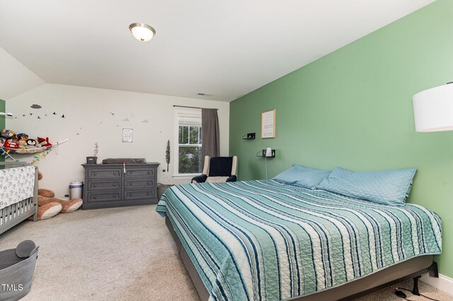 carpeted bedroom with lofted ceiling