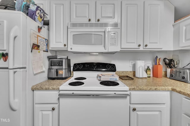 kitchen with white appliances and white cabinetry