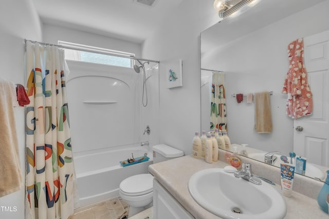 bathroom featuring toilet, shower / bath combo with shower curtain, and vanity
