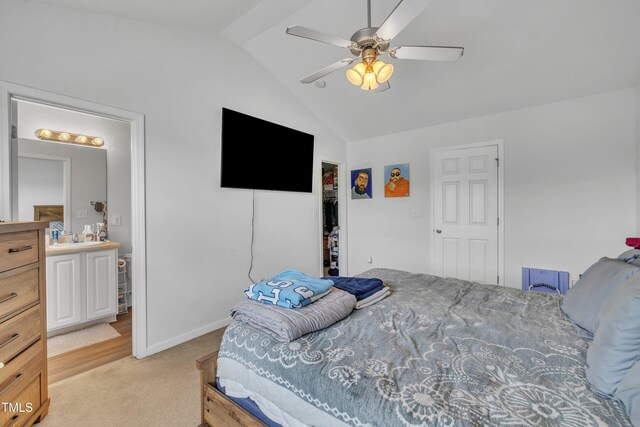 bedroom featuring vaulted ceiling, light colored carpet, a sink, a ceiling fan, and baseboards