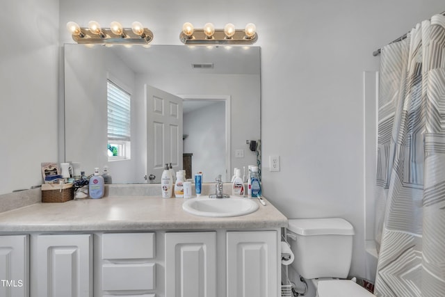 bathroom featuring vanity, toilet, and a shower with curtain