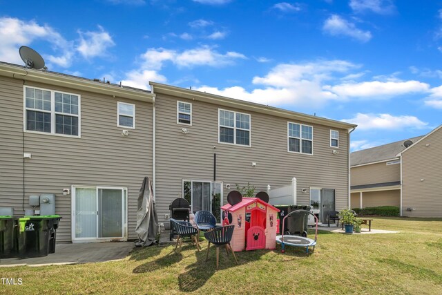 back of house with a yard and a patio area