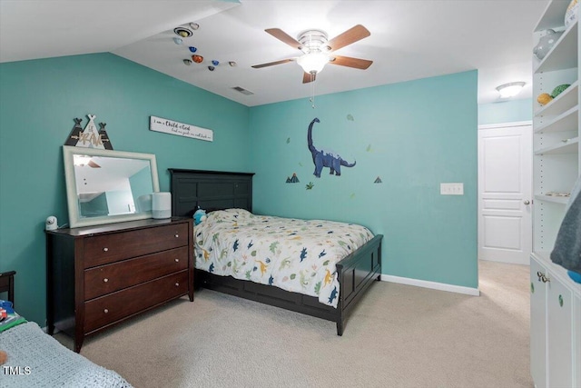 bedroom with light colored carpet, a ceiling fan, baseboards, and lofted ceiling