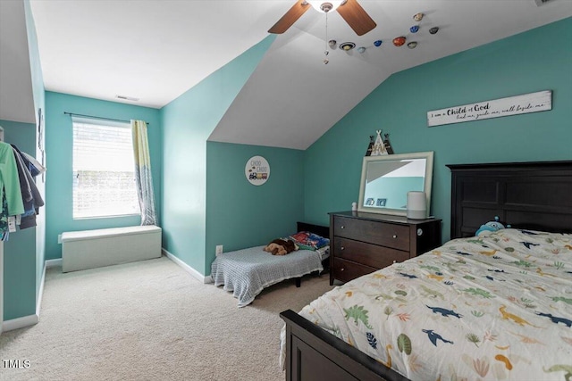 carpeted bedroom with baseboards, vaulted ceiling, and a ceiling fan