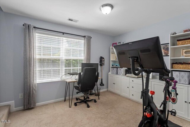 office space featuring light carpet and baseboards