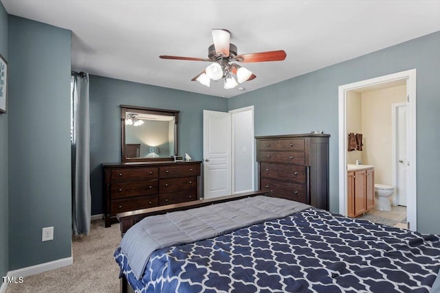 bedroom featuring baseboards, carpet flooring, ensuite bath, and ceiling fan