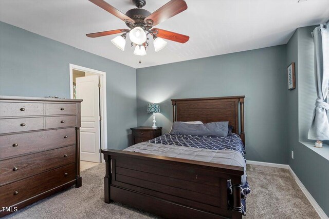 bedroom with light carpet, baseboards, and ceiling fan