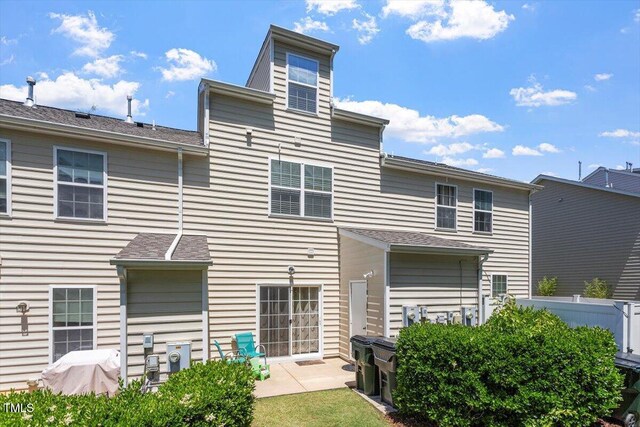 back of property featuring a patio and fence