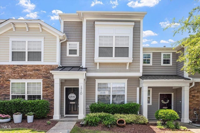 townhome / multi-family property with stone siding