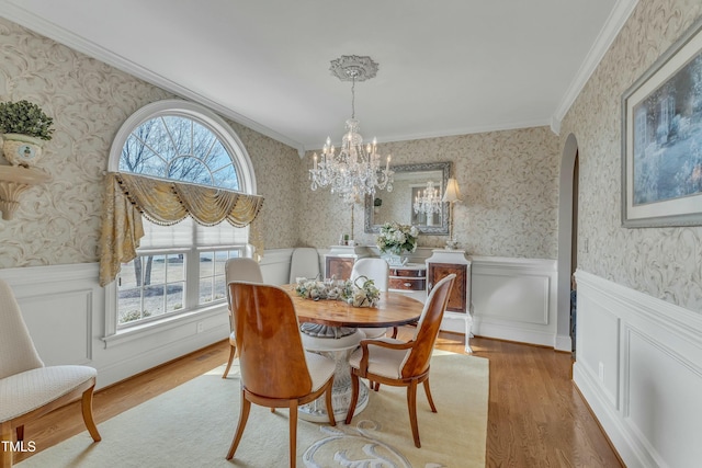 296 Shoreline Dr, Princeton, NC 27569 - dining room with wallpapered walls, wood finished floors, wainscoting, and an inviting chandelier