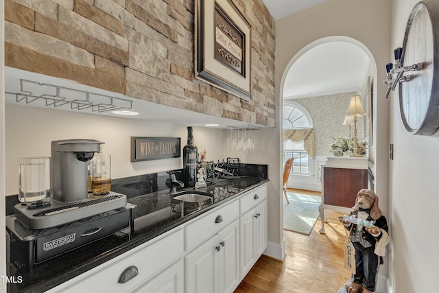 296 Shoreline Dr, Princeton, NC 27569 - kitchen with wood finished floors, a sink, dark stone counters, white cabinetry, and arched walkways