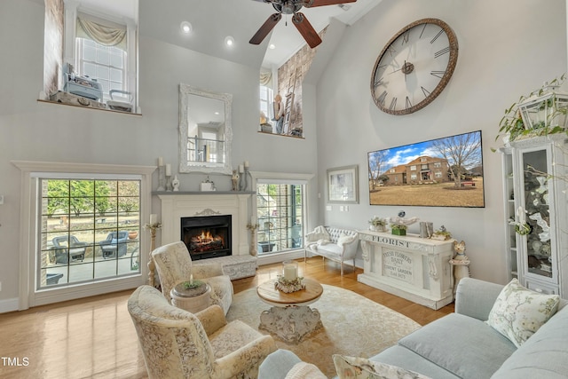296 Shoreline Dr, Princeton, NC 27569 - living area with a wealth of natural light, a lit fireplace, a ceiling fan, and high vaulted ceiling