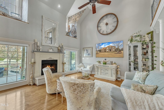 296 Shoreline Dr, Princeton, NC 27569 - living room featuring wood finished floors, high vaulted ceiling, ceiling fan, a lit fireplace, and baseboards