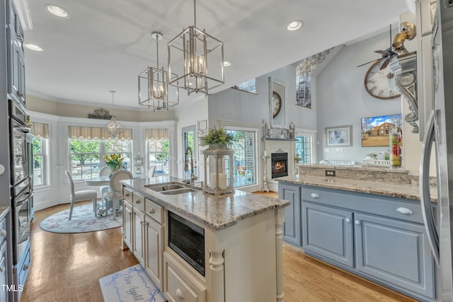 296 Shoreline Dr, Princeton, NC 27569 - kitchen with light wood-style floors, an inviting chandelier, appliances with stainless steel finishes, and a sink