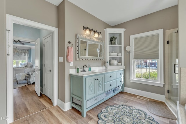 296 Shoreline Dr, Princeton, NC 27569 - ensuite bathroom with baseboards, a shower stall, vanity, connected bathroom, and wood finished floors