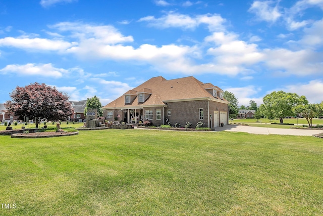 296 Shoreline Dr, Princeton, NC 27569 - rear view of house with concrete driveway, brick siding, an attached garage, and a yard
