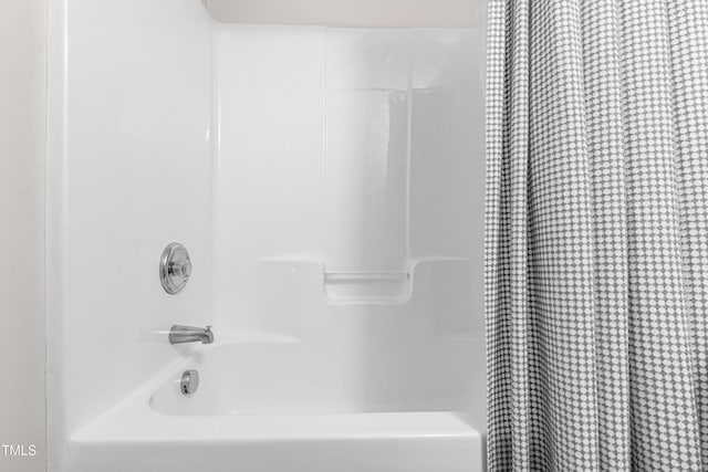 full bathroom featuring shower / bath combo with shower curtain