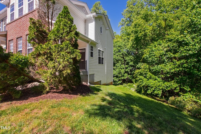 view of side of property with a yard