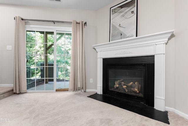 detailed view of carpet floors, a fireplace with flush hearth, and baseboards