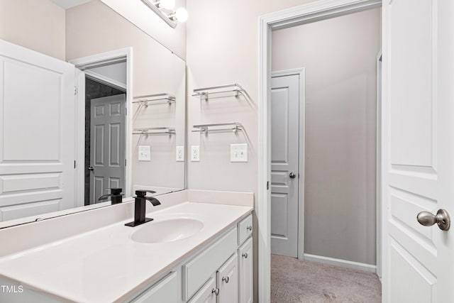 bathroom with vanity and baseboards