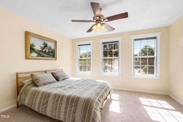 bedroom with carpet flooring, baseboards, and a ceiling fan