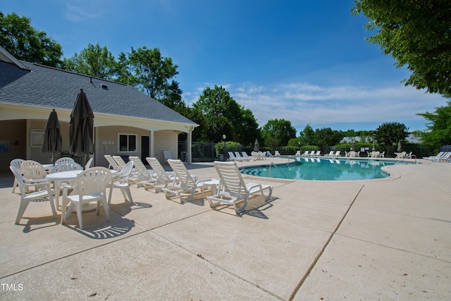 community pool featuring a patio area and fence