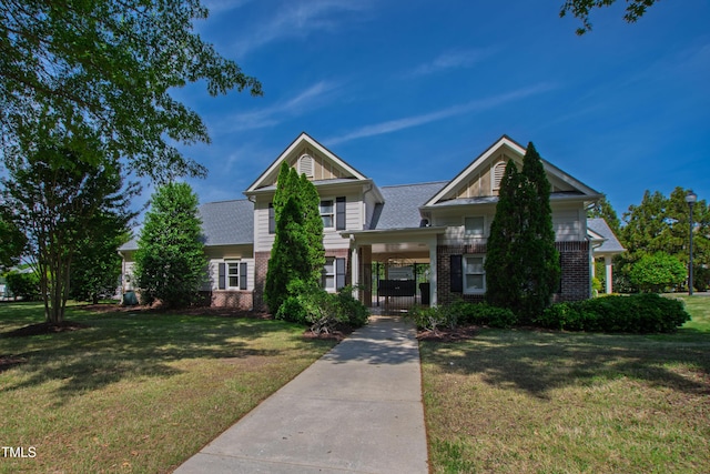 view of front of property featuring brick siding and a front lawn