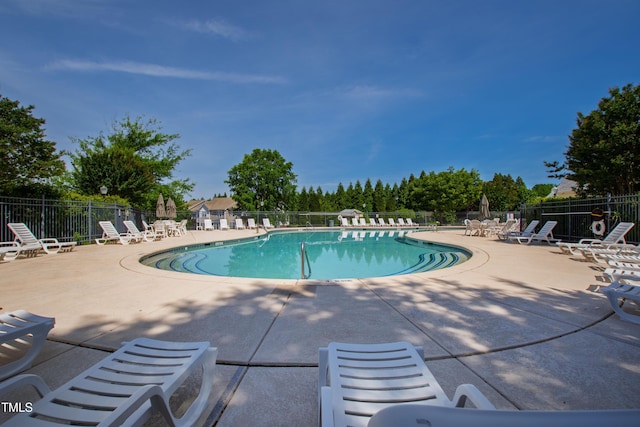 community pool featuring a patio area and fence