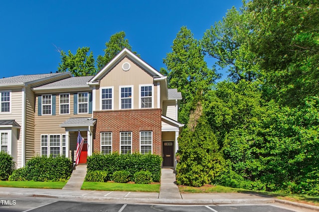 view of front of home featuring uncovered parking and brick siding