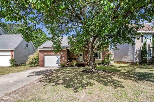 view of property hidden behind natural elements featuring a front lawn, driveway, and an attached garage