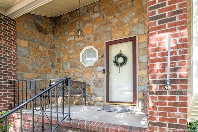 doorway to property with stone siding and brick siding