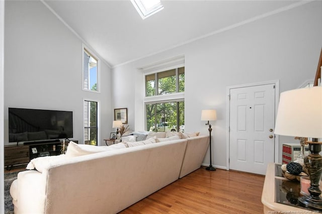 living room with high vaulted ceiling and light wood-style floors