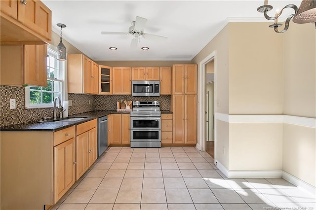 kitchen with ceiling fan, a sink, crown molding, stainless steel appliances, and tasteful backsplash