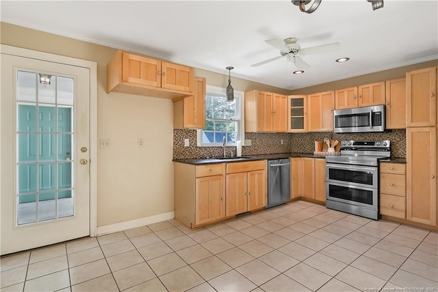 kitchen with a sink, light brown cabinets, dark countertops, and appliances with stainless steel finishes
