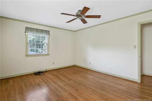 spare room with baseboards, ceiling fan, light wood-style flooring, and crown molding