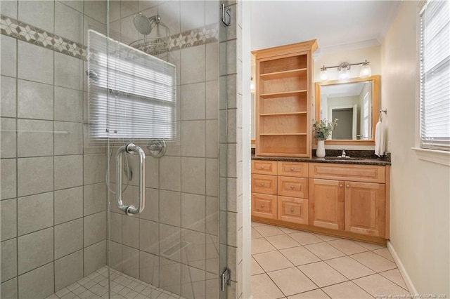 full bath with tile patterned flooring, ornamental molding, a shower stall, and vanity