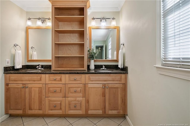 bathroom featuring tile patterned flooring, crown molding, and a sink