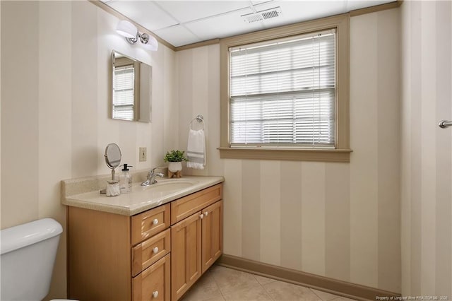 bathroom with toilet, baseboards, visible vents, tile patterned flooring, and vanity