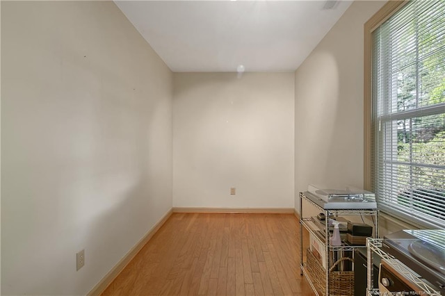 unfurnished room featuring light wood-style flooring and baseboards