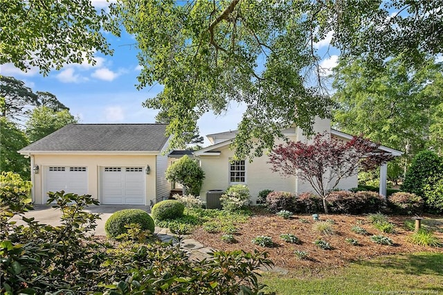 view of front of home featuring stucco siding, cooling unit, and an outbuilding