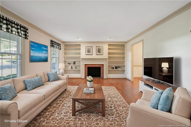 living area featuring crown molding, wood finished floors, and built in shelves