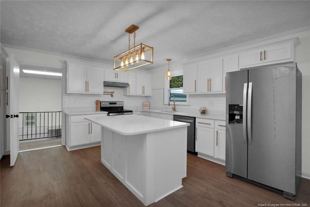 kitchen featuring under cabinet range hood, stainless steel appliances, decorative backsplash, and white cabinets
