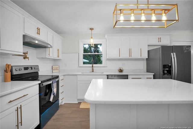 kitchen featuring a sink, white cabinets, under cabinet range hood, appliances with stainless steel finishes, and tasteful backsplash