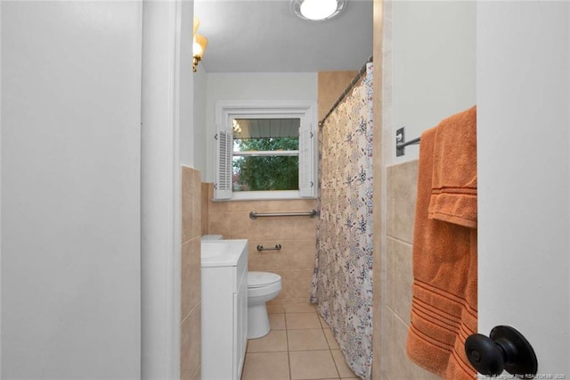 full bath featuring tile walls, toilet, a wainscoted wall, vanity, and tile patterned flooring