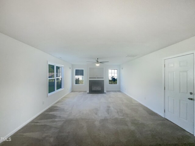 4126 Amber Stone Way, Durham, NC 27704 - unfurnished living room with a fireplace with flush hearth, light carpet, visible vents, and ceiling fan