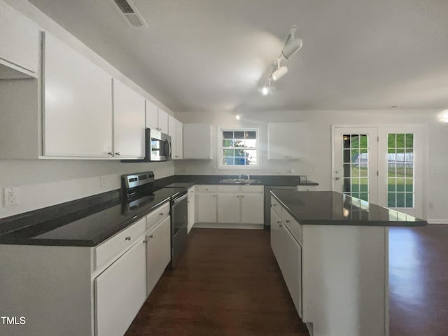 4126 Amber Stone Way, Durham, NC 27704 - kitchen with white cabinetry, dark countertops, stainless steel appliances, and a sink