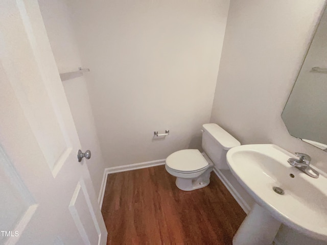 4126 Amber Stone Way, Durham, NC 27704 - bathroom with a sink, toilet, baseboards, and wood finished floors
