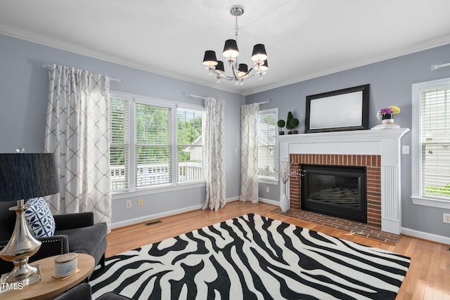 living area with a chandelier, plenty of natural light, wood finished floors, and crown molding