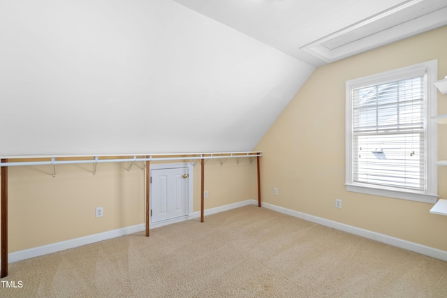 bonus room with lofted ceiling, carpet, and baseboards