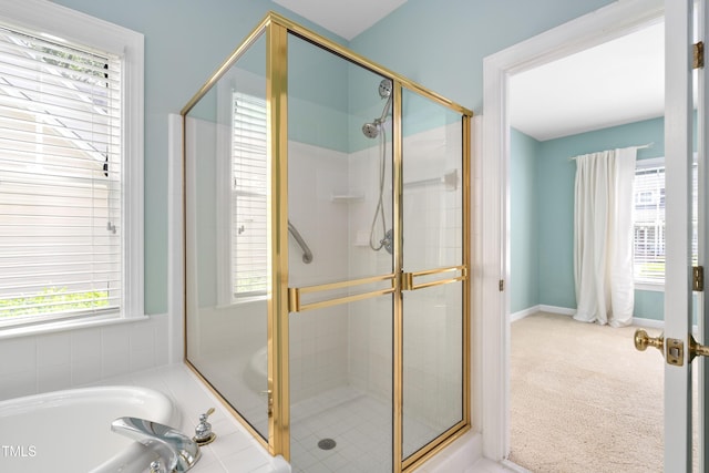 bathroom with a shower stall and a bath